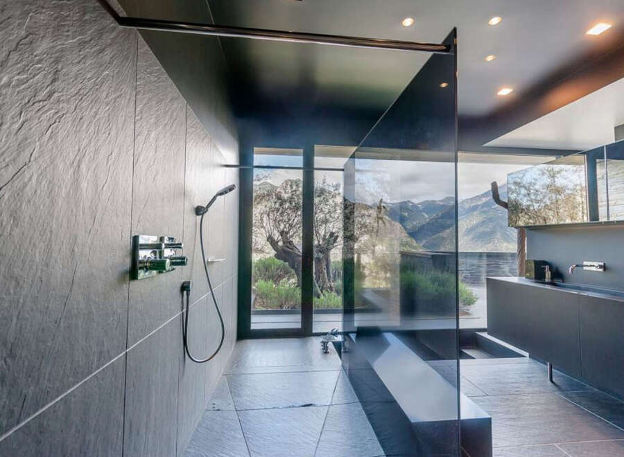 Indulge in this luxurious bathroom featuring a walk-in shower with stunning mountain views.
