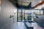 Indulge in this luxurious bathroom featuring a walk-in shower with stunning mountain views.