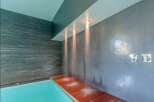 Indulge in ultimate luxury with this stunning indoor pool featuring a built-in rain shower system.