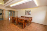 This stunning property boasts a spacious dining area with a large wooden table and built-in benches, perfect for family gatherings.