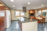 This stunning kitchen boasts a large island with granite countertops and modern appliances, perfect for entertaining.