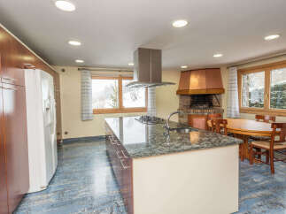 This stunning kitchen boasts a large island with granite countertops and modern appliances, perfect for entertaining.