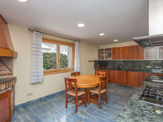 This stunning kitchen boasts a beautiful granite countertop, modern appliances, and ample cabinetry.