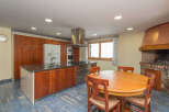 This stunning kitchen boasts granite countertops, wooden cabinetry, and stainless steel appliances.