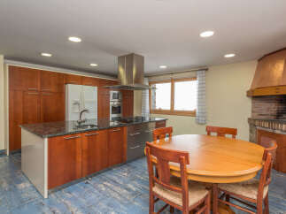 This stunning kitchen boasts granite countertops, wooden cabinetry, and stainless steel appliances.