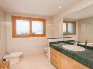 This stunning bathroom boasts a spacious design with modern fixtures and finishes.