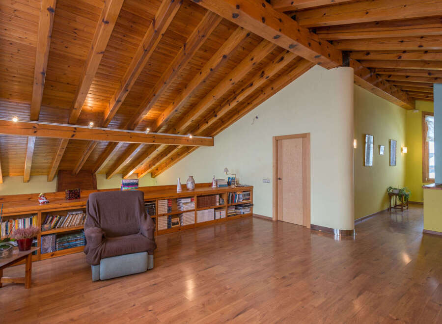 This stunning property boasts a spacious attic conversion with exposed wooden beams and a cozy reading nook.