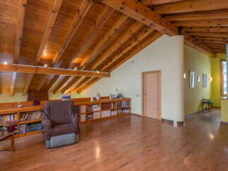 This stunning property boasts a spacious attic conversion with exposed wooden beams and a cozy reading nook.
