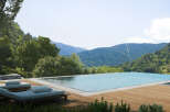 Luxury mountain retreat with infinity pool offering breathtaking panoramic views.