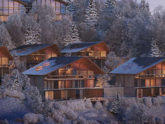 Luxury mountain homes nestled in a snowy forest.