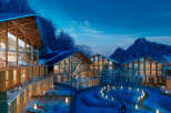 Luxury mountain resort nestled in a snowy landscape.