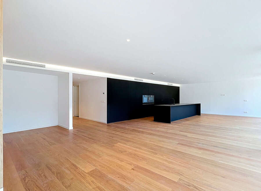 Experience modern living in this spacious, open-concept home featuring a sleek black kitchen island and integrated cabinetry.