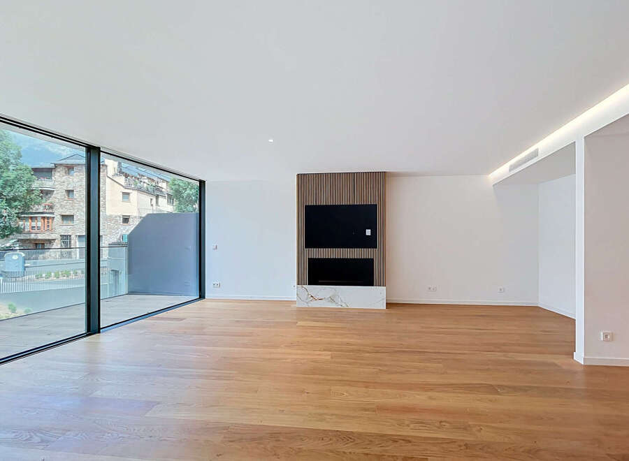 Experience modern living in this spacious, light-filled apartment featuring a sleek entertainment center with a fireplace and a wall-mounted TV.