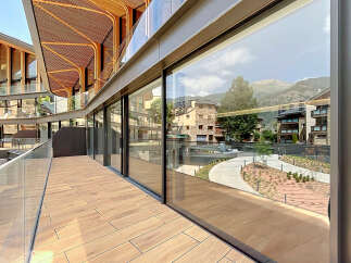 Experience modern living with this stunning property featuring expansive glass windows that offer breathtaking mountain views.