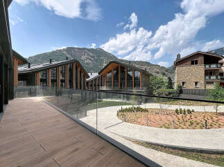 Experience modern mountain living in this stunning property featuring unique architectural design with sweeping curved roofs and extensive glass facades.