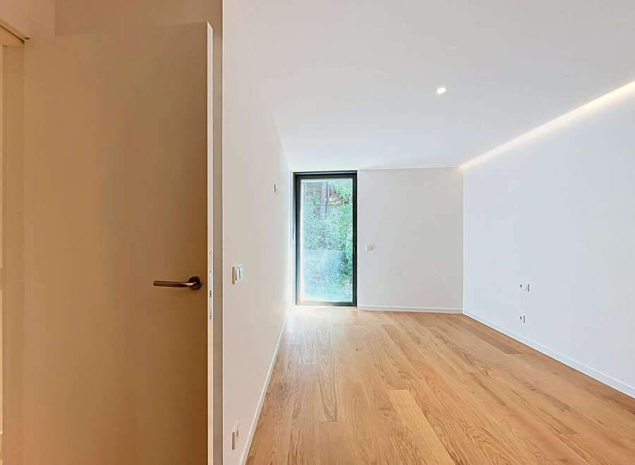 Step into this bright and airy room featuring a sleek modern design and warm hardwood floors.
