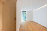 Step into this bright and airy room featuring a sleek modern design and warm hardwood floors.