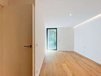 Step into this bright and airy room featuring a sleek modern design and warm hardwood floors.