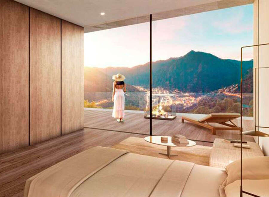 Wake up to breathtaking mountain views from this luxurious bedroom.