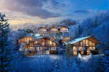 Luxury ski-in/ski-out homes nestled in a snowy mountainside.