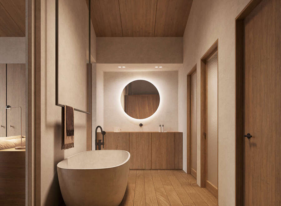 This stunning bathroom boasts a minimalist design with a freestanding bathtub, sleek wooden cabinetry, and a large circular mirror.