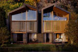 Luxury duplexes nestled in nature, boasting expansive windows and private balconies.