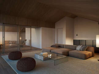 This stunning property boasts a spacious living area with a modern sectional sofa and unique coffee table, perfect for relaxation and entertaining.