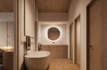 This stunning bathroom boasts a minimalist design with a freestanding bathtub, sleek wooden cabinetry, and a large circular mirror.