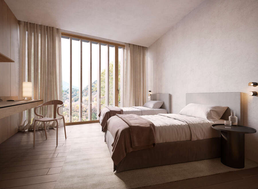 Wake up to breathtaking views from this serene bedroom, featuring twin beds and a minimalist design.