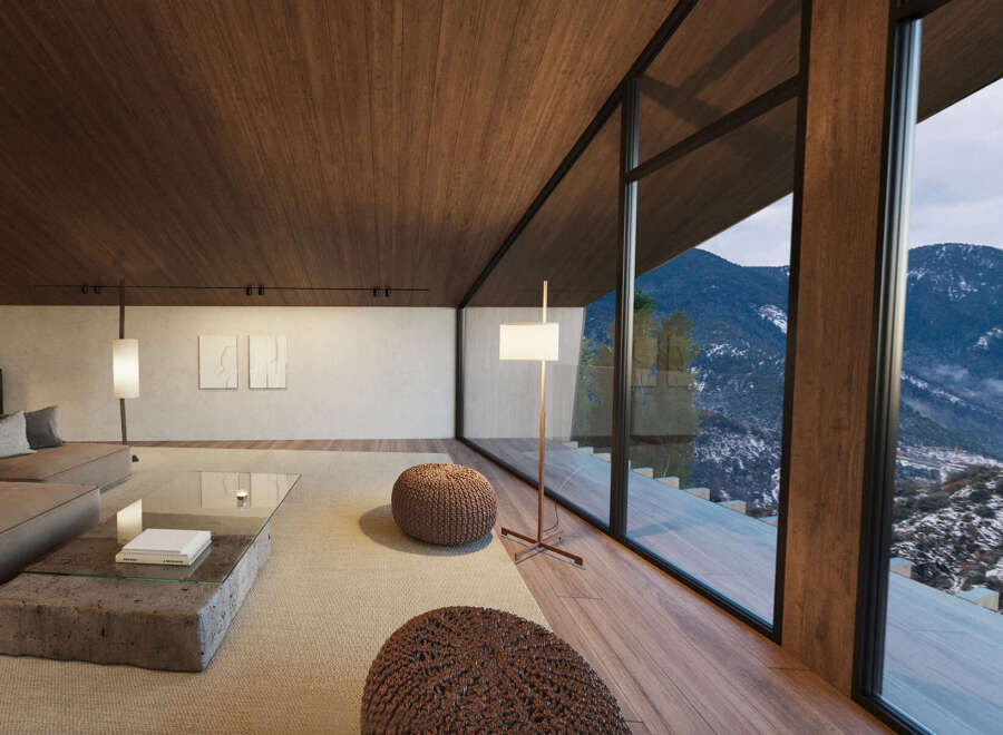 Mountain view living room with floor to ceiling windows, hardwood floors, and cozy seating.