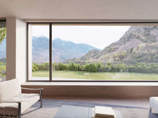 Stunning mountain views from this luxurious home's expansive window wall.