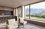 This stunning property boasts breathtaking mountain views from its expansive windows, creating a serene and tranquil atmosphere.