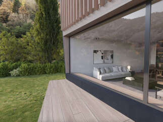 Modern house with large windows showcasing stunning views of nature.