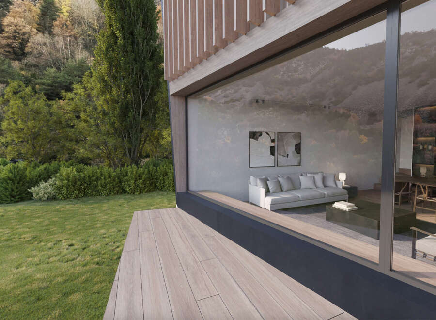 Modern house with large windows showcasing stunning views of nature.