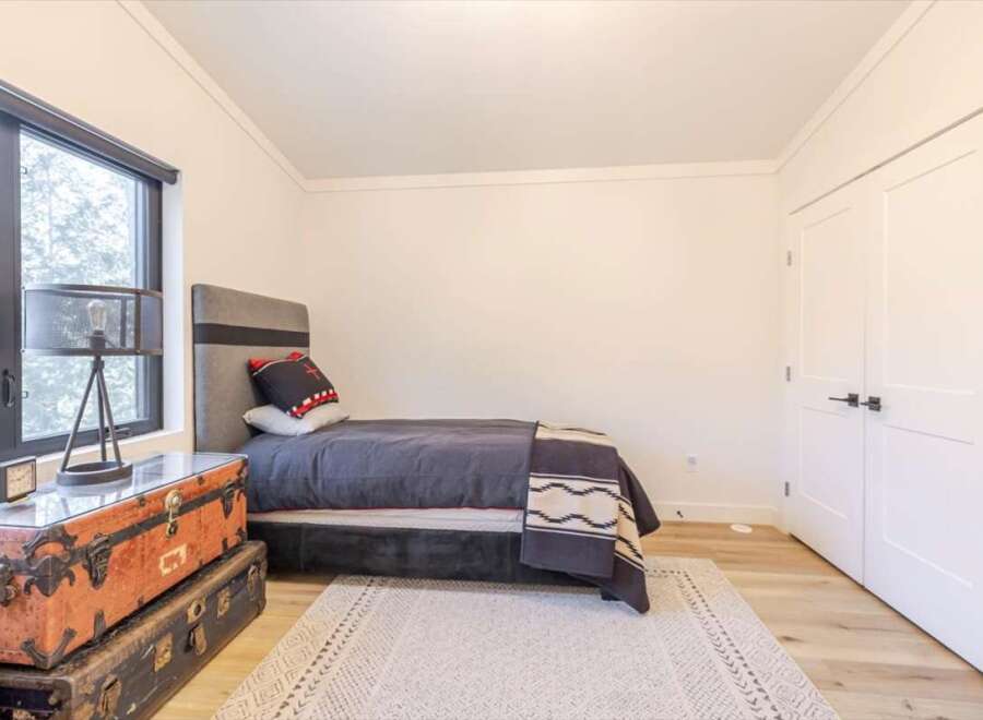 Discover a cozy bedroom retreat! This space features a stylish bed, perfect for relaxation.