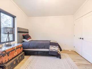 Discover a cozy bedroom retreat! This space features a stylish bed, perfect for relaxation.