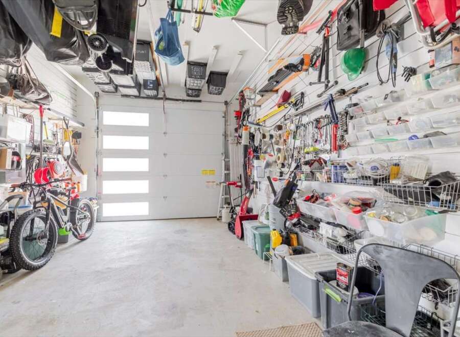 This well-organized garage offers ample storage solutions, perfect for keeping your tools and equipment neatly arranged.
