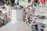 This well-organized garage offers ample storage solutions, perfect for keeping your tools and equipment neatly arranged.