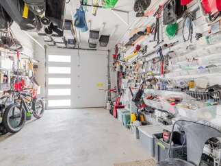 This well-organized garage offers ample storage solutions, perfect for keeping your tools and equipment neatly arranged.