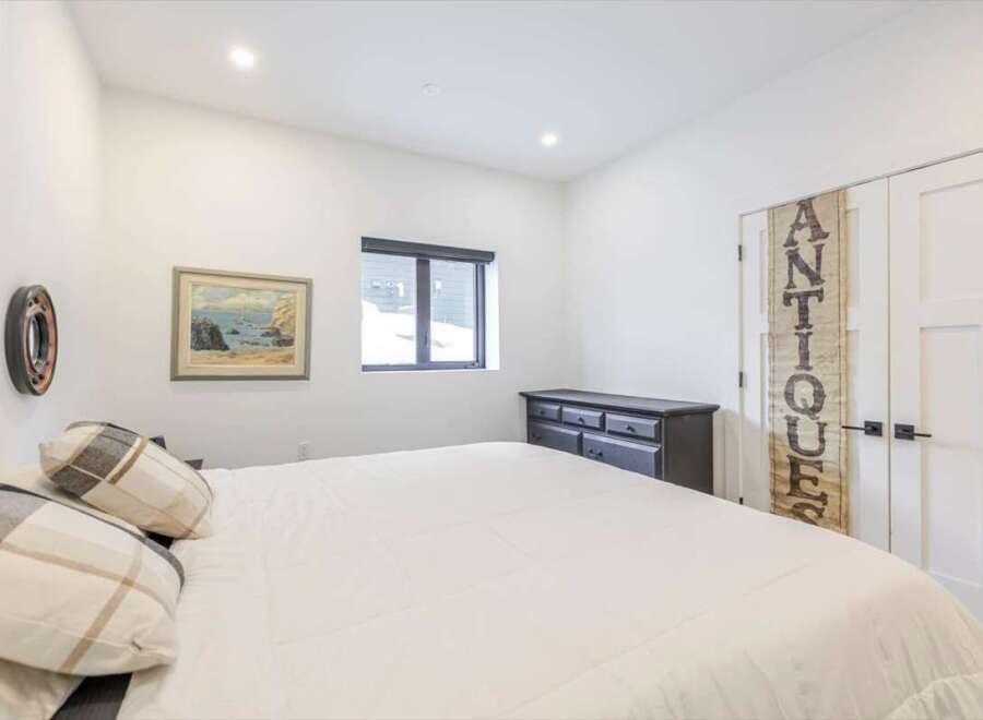 This bedroom offers a serene retreat with its bright, airy ambiance and minimalist design.