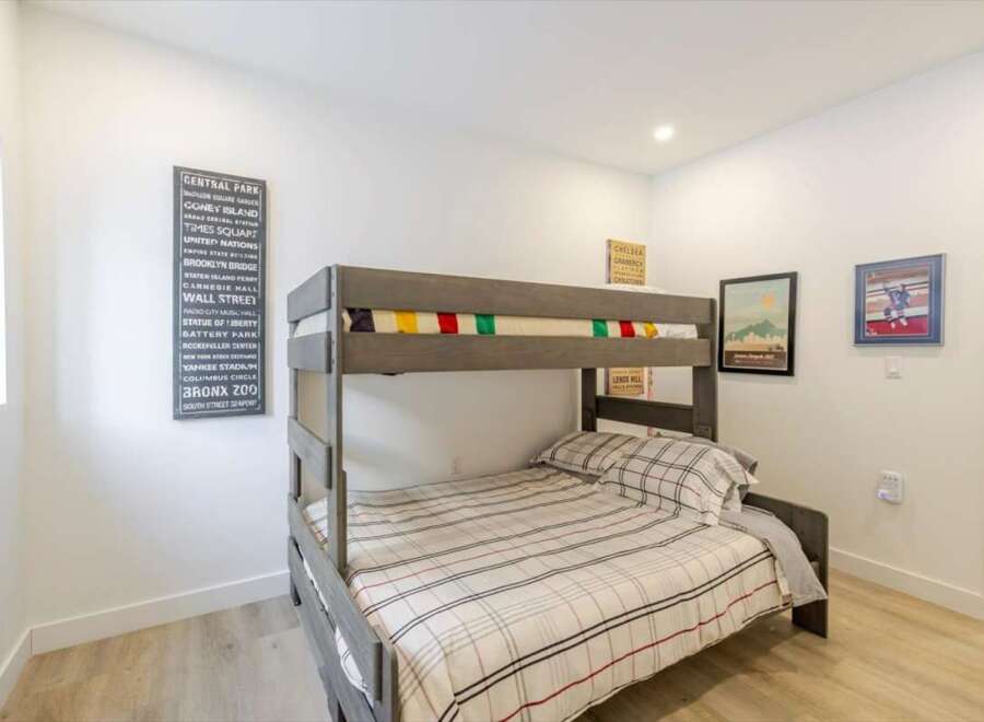 This cozy bedroom features a stylish bunk bed, perfect for accommodating guests or creating a fun space for kids.
