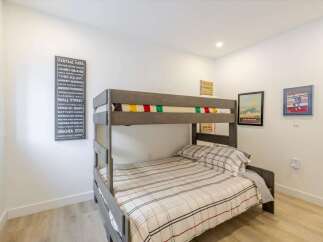This cozy bedroom features a stylish bunk bed, perfect for accommodating guests or creating a fun space for kids.