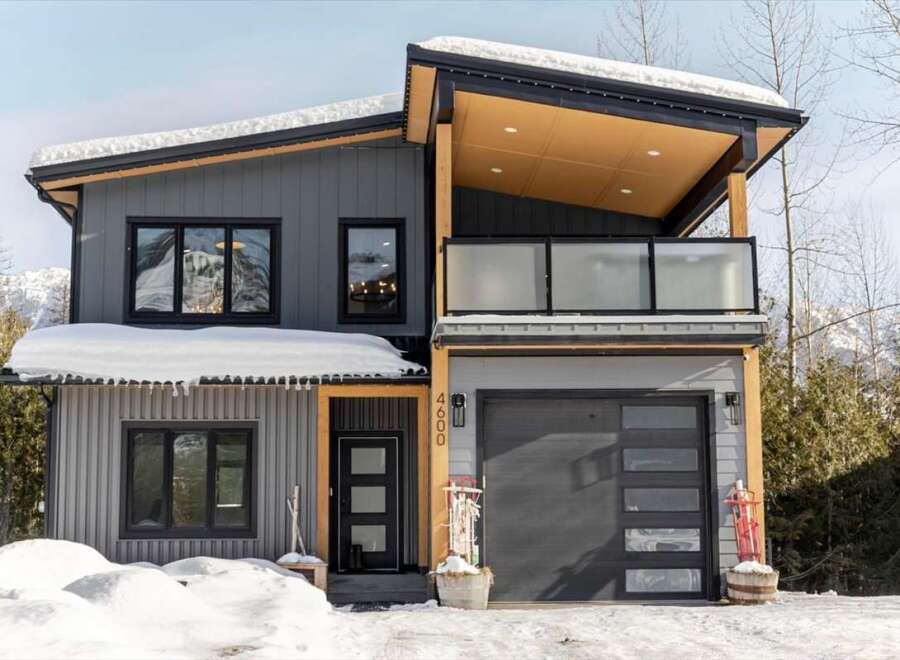This stunning modern home boasts a sleek design with a contemporary facade.