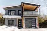 This stunning modern home boasts a sleek design with a contemporary facade.
