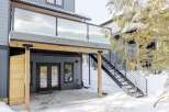 Discover modern living with this stunning property featuring a sleek glass-railed balcony.