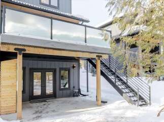 Discover modern living with this stunning property featuring a sleek glass-railed balcony.