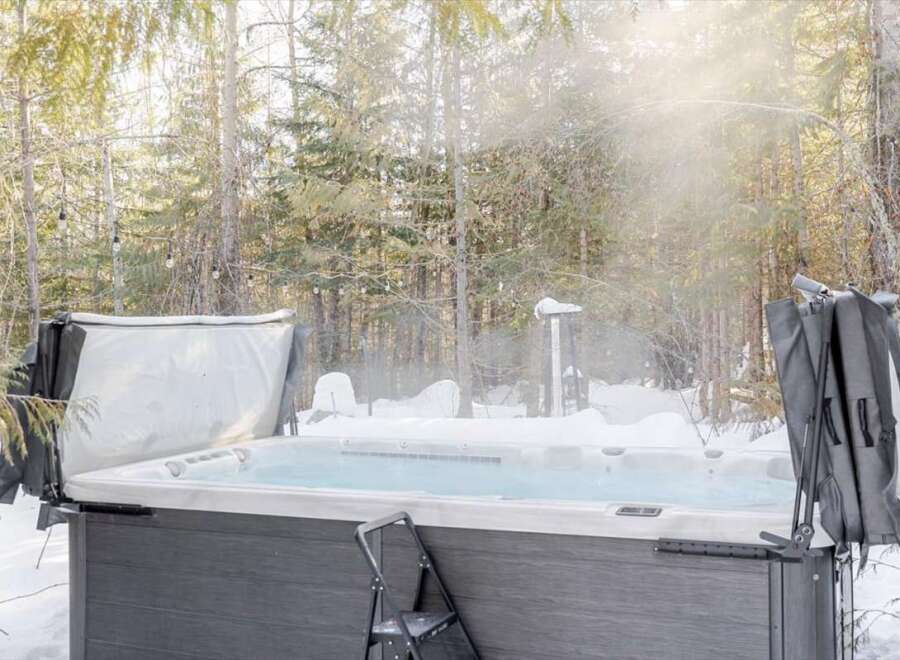 Enjoy a relaxing soak in the hot tub surrounded by a winter wonderland.