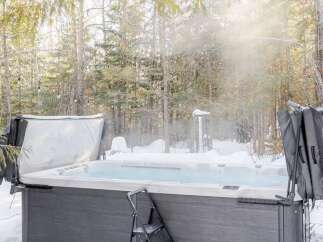 Enjoy a relaxing soak in the hot tub surrounded by a winter wonderland.