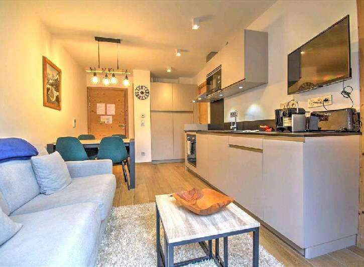This stunning apartment boasts a modern open-plan kitchen and living area, perfect for entertaining.