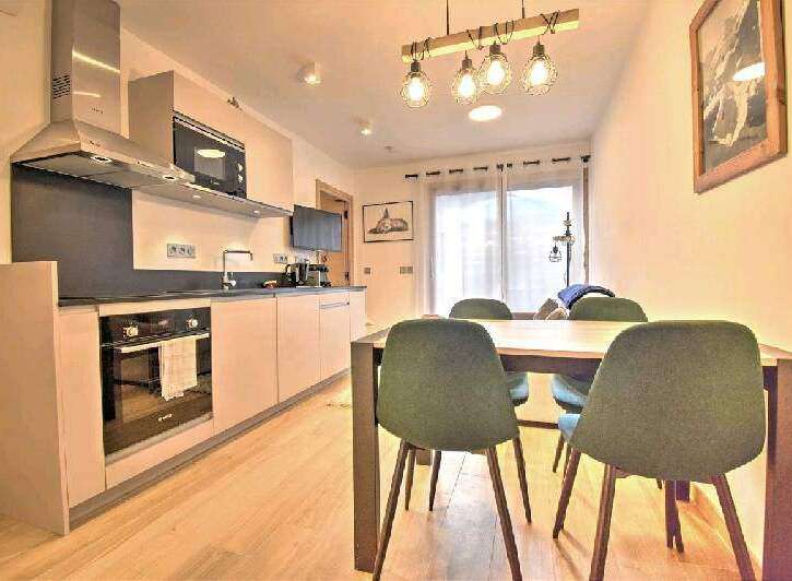 Modern apartment with open-plan kitchen and dining area.